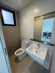 Modern bathroom with white fixtures and glass shower partition