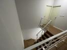 Modern staircase with white walls and metal banisters