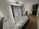 Modern bedroom with large bed and air conditioning