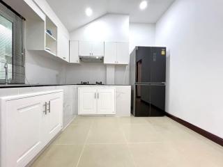 Modern kitchen interior with white cabinetry and stainless steel appliances