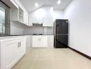 Modern kitchen interior with white cabinetry and stainless steel appliances