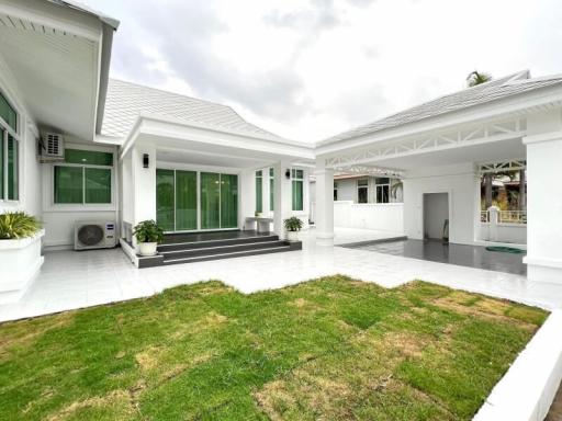 Modern single-story detached house with a well-maintained front yard and spacious driveway