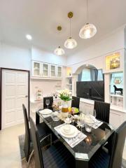 Elegantly set dining table in a modern dining room with decorative lighting