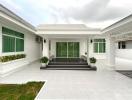 Spacious front porch of a modern home with elegant steps and landscaping