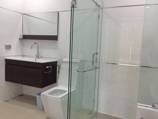 Modern bathroom with glass shower and white tiling
