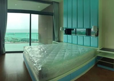 Spacious bedroom with a seaside view and modern design