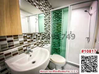 Modern bathroom interior with mosaic tiles and glass shower cubicle