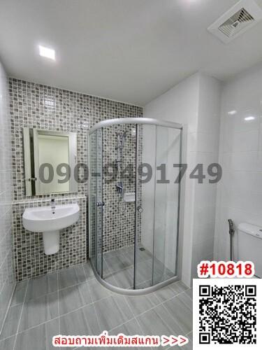 Modern bathroom with glass shower enclosure and mosaic tiles