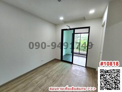 Spacious empty bedroom with wooden flooring and balcony access
