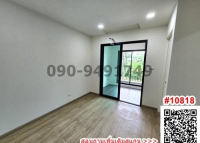 Spacious empty bedroom with wooden flooring and balcony access
