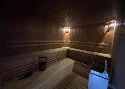 Cozy wooden sauna with built-in benches and soft lighting