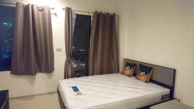 Spacious bedroom with double bed and city view