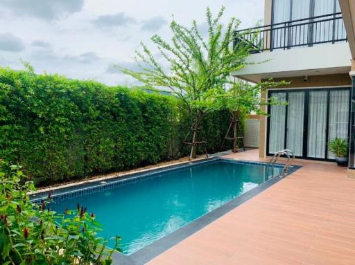 Private swimming pool with terrace and greenery in a residential property