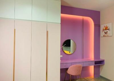 Modern bedroom with stylish purple vanity and ambient lighting
