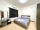 Spacious Bedroom with Modern Furniture and Air Conditioning