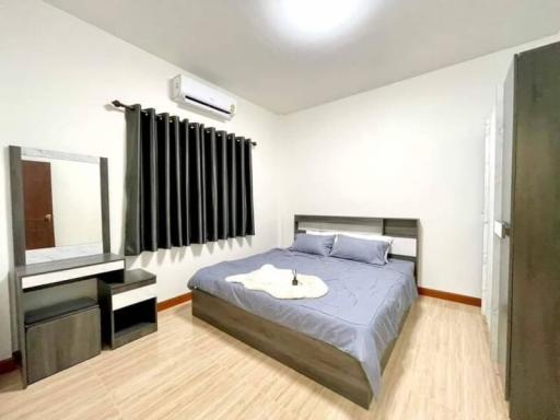 Spacious Bedroom with Modern Furniture and Air Conditioning