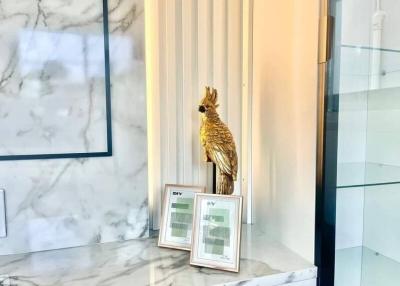 Elegant bathroom interior with marble surfaces and golden bird statue