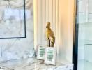 Elegant bathroom interior with marble surfaces and golden bird statue