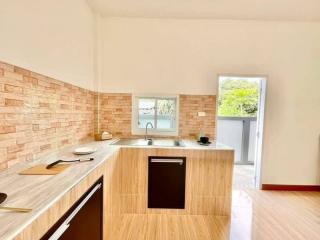 Modern kitchen with wooden cabinets and brick-style backsplash
