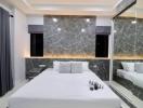 Modern bedroom with large mirror and sophisticated lighting