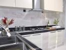 Modern kitchen with stainless steel appliances and marble backsplash