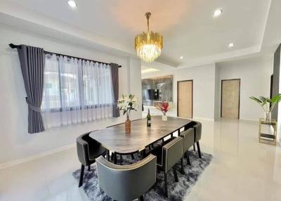 Elegant dining room with modern chandelier and expansive table