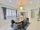 Elegant dining room with modern chandelier and expansive table