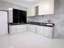 Modern spacious kitchen with glossy countertops and marble flooring