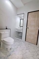 Modern bathroom with marble tiles, and elegant fixtures