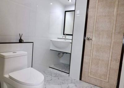 Modern bathroom with marble tiles, and elegant fixtures