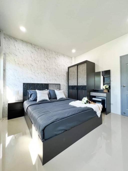 Modern bedroom with white walls and a large bed