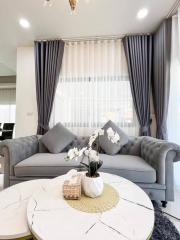 Elegant living room with plush sofa and marble-top coffee table