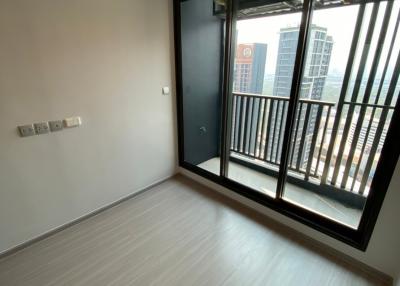 Empty bedroom with air conditioning unit and balcony door