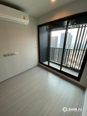 Empty bedroom with air conditioning unit and balcony door