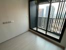 Empty bedroom with air conditioning unit and balcony door