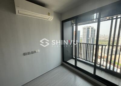 Modern bedroom with large window and balcony access