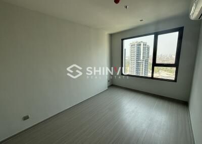 empty bedroom with large window and city view