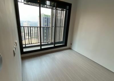 Empty bedroom with large window and balcony access