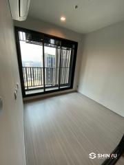 Empty bedroom with large window and balcony access