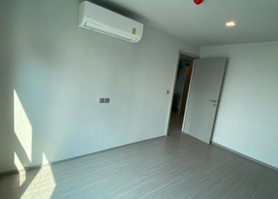 Empty bedroom with hardwood floors and air conditioning unit