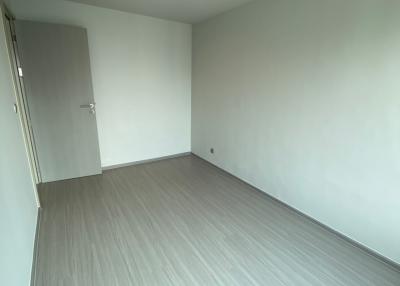 Empty modern room with grey flooring and white walls