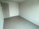 Empty modern room with grey flooring and white walls