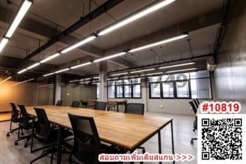 Spacious modern meeting room with large table and chairs