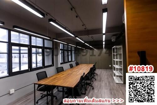 Spacious modern meeting room interior with long table, chairs and large windows