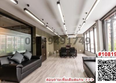 Modern office space with large windows and comfortable seating area
