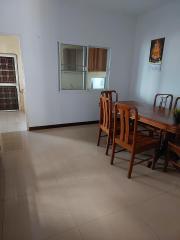 Spacious dining room with wooden furniture and tiled flooring