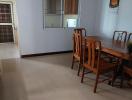 Spacious dining room with wooden furniture and tiled flooring