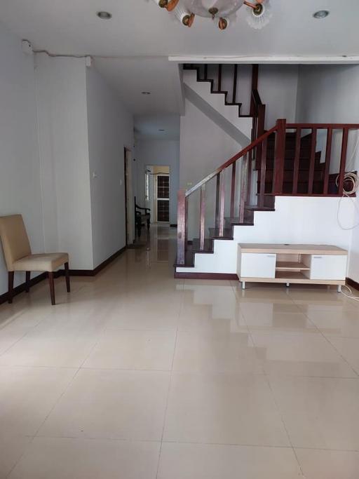 Spacious living room with staircase and tiled flooring