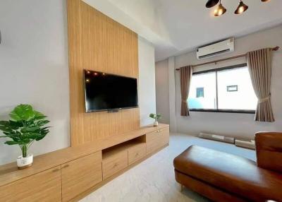 Modern living room with wooden tv cabinet and cozy ambiance