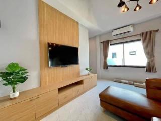 Modern living room with wooden tv cabinet and cozy ambiance